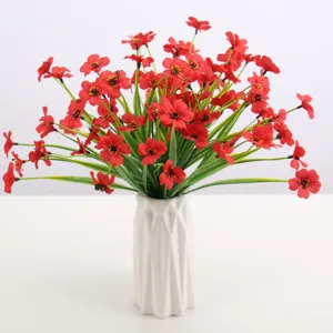 Artificial red flower bouquet in white geometric vase for home decor and floral arrangements.