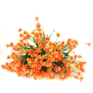 Artificial plastic flower bouquet, vibrant orange decorative plant for home and office interior decor.
