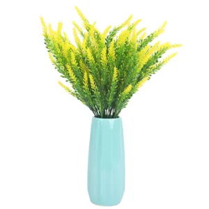Artificial lavender bouquet in blue ceramic vase, perfect desktop floral home decor.