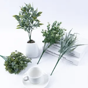 Detailed view of artificial eucalyptus leaf bouquets and green plants for home and wedding decor setup.
