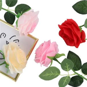 Artificial rose detail view, premium silk flower with realistic green leaves for home decor.