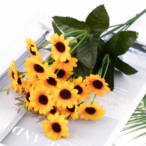Artificial sunflower bouquet detail showing vibrant yellow petals and leaves for decor.