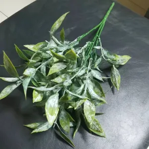 Detailed view of artificial eucalyptus leaves branch, frosted green plant for floral arrangements.