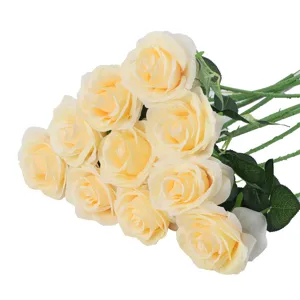 Artificial rose bouquet detail view, champagne silk flowers with green stems for home and wedding decor.