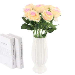 Artificial rose flower bouquet with white ceramic vase for home and wedding decoration.
