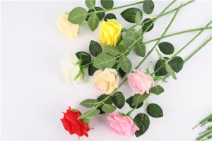 Artificial rose flower detail view showing vibrant color assortment and realistic green leaf stems.