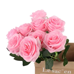 Detailed close-up of artificial pink roses bouquet in brown paper bag, floral decor.