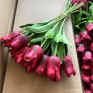 Detailed shot of artificial PU tulip flowers bunch with realistic petals and green stems.