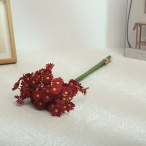 Artificial silk flower bouquet detail shot, red daisy ornaments for home decoration.