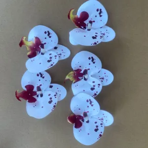 Artificial white orchid flower heads with purple spots, perfect for DIY decor and crafts.