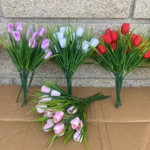 Artificial tulip flower bouquet detail shot, vibrant colors with green leaves for home decor.