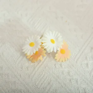 Close-up detail of artificial daisy flowers bouquet small home table decor artificial floral.