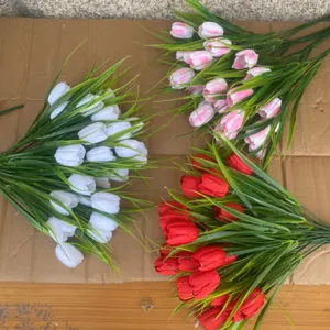 Detail shot of artificial tulip flowers bundles in white, pink and red for decoration.