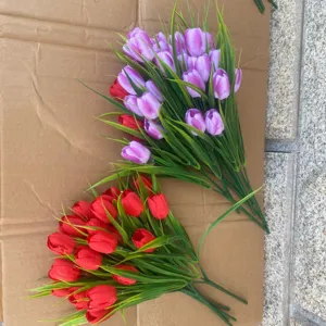 Artificial tulip bouquet detail, faux flowers with green leaves for home and party decoration.