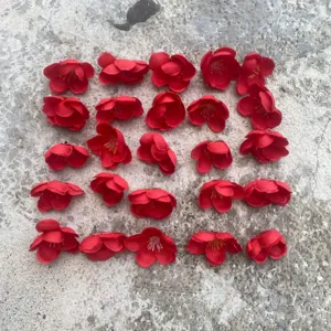Red artificial plum blossom flower heads for DIY crafts, clothing, and floral accessories.