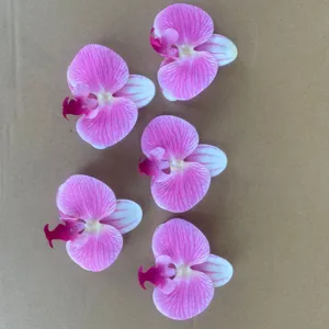 Artificial phalaenopsis orchid flower heads detail view for DIY crafts and wedding decoration.