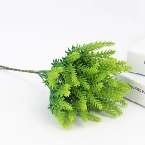 Artificial lavender plastic flower bunch detail shot, green plant decor for home fence.