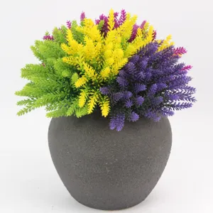 Detail shot of colorful artificial lavender flowers in a dark grey pot, perfect for home decor.