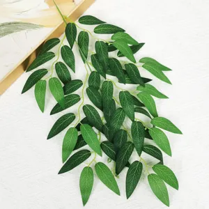 Close up detail of artificial willow leaves branch, realistic green foliage for home decor.