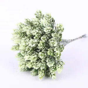 Detailed view of artificial frosted pine branch bouquet, decorative plant material for DIY craft.