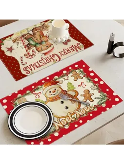 Close-up of Christmas cotton linen placemat featuring festive gingerbread man and snowman print.