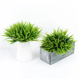 Artificial green grass potted plants set with white vase and wooden box planter for decor.