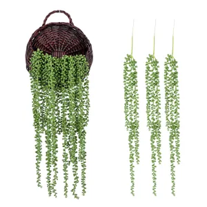 Artificial string of pearls succulent hanging plant detail view, plastic vine for wall decor.
