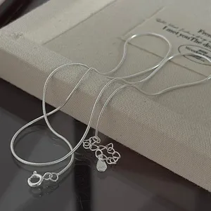 Detailed close-up view of a minimalist S925 sterling silver snake bone chain necklace.