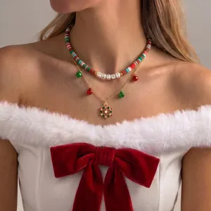 Detailed shot of Christmas layered necklace featuring colorful beads, cute bell charms and snowflake pendant.