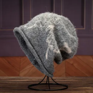 Grey fuzzy slouchy knit beanie hat with abstract butterfly pattern, cozy autumn and winter style.