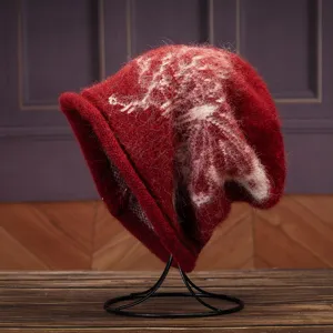 Detailed close-up view of a cozy red slouchy knitted hat with a white butterfly pattern.
