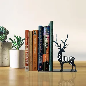 Detailed view of black metal deer bookend supporting books on a tidy wooden desktop setup.