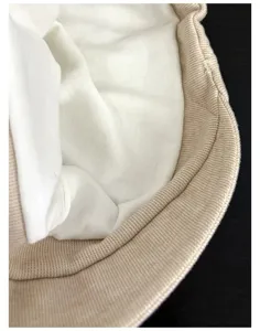 Detailed shot of the retro knitted slouchy hat brim and soft white inner lining fabric.