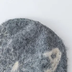 Close up detail of fuzzy grey winter knit slouchy beanie hat soft wool texture cozy style