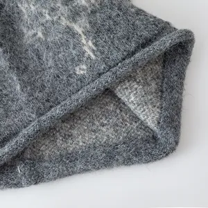 Detail view of the retro butterfly slouchy knitted beanie, soft wool texture, cozy winter hat.