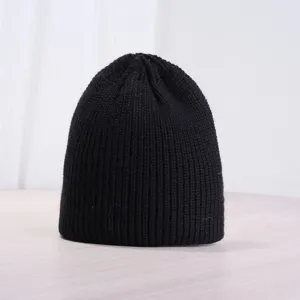 Close-up detail of black ribbed knit beanie winter warm cozy hat texture display.