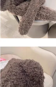 Detailed close-up view of a brown plush bear ear integrated hat and scarf showing soft texture.