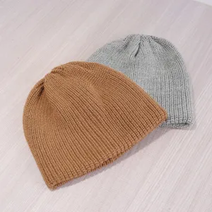 Solid color knitted winter beanie hat, thick warm casual skull cap for unisex wear.