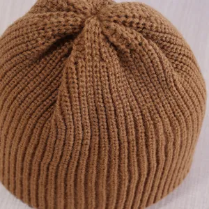 Brown knitted beanie hat detail view, thick ribbed wool warm cap for men and women.
