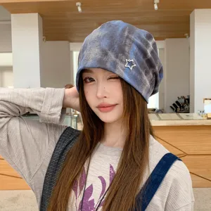 Close-up detail of the retro tie-dye slouchy beanie with stylish star accent, soft fabric.