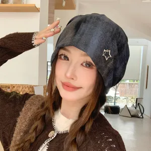Detail view of the retro tie-dye slouchy beanie hat featuring a stylish metallic star charm for women.