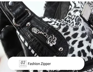 Close-up detail of women's black and white animal print handbag featuring metal zipper hardware.