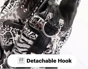 Handbag detail shot showcasing metallic detachable hook, black and white animal print texture.
