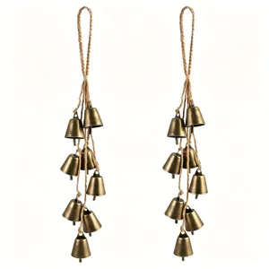 Vintage hanging brass bells with jute rope rustic wind chime for home and holiday decor.
