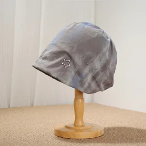 Close-up detail of the vintage tie-dye winter pile hat featuring a delicate metal star.