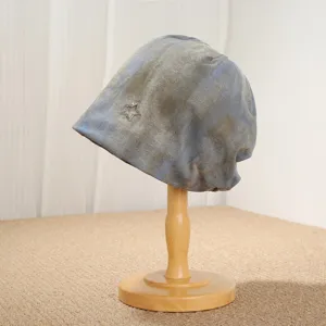 Close-up view of the vintage tie-dye slouchy hat featuring a delicate metal star accessory.