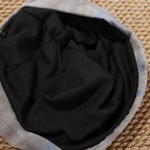 Retro tie-dye slouchy beanie detail view, soft black lining, comfortable autumn winter hat style.