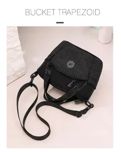 Detail view of the black grid pattern bucket cross-body bag with adjustable strap and chic design.