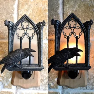 Detailed view of gothic raven wall night light with plug-in design and warm LED glow effect.