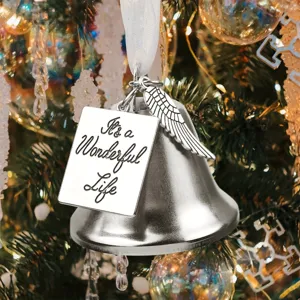 Detail view of a silver angel wing bell Christmas tree ornament with engraved plaque.